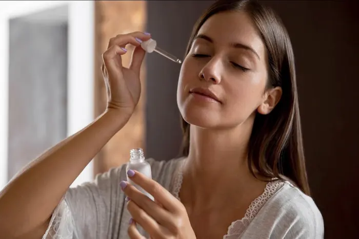 Consumer using a skincare serum as part of a daily skincare routine
